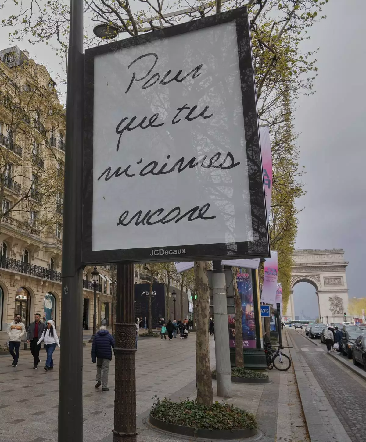 FILE - A poster featuring the French title of Céline Dion's song "If That's What It Takes," promoting autumn concerts in France on the Champs-Élysées in Paris, Wednesday, March 25, 2026. (AP Photo/Michel Euler)