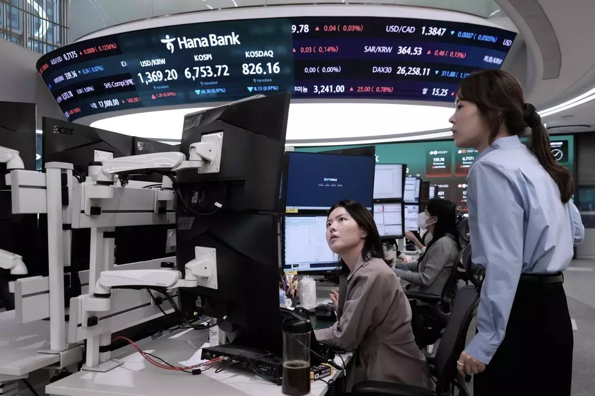 Currency traders watch monitors at the foreign exchange dealing room of the Hana Bank headquarters in Seoul, South Korea, Tuesday, Sept. 1, 2026. (AP Photo/Ahn Young-joon)