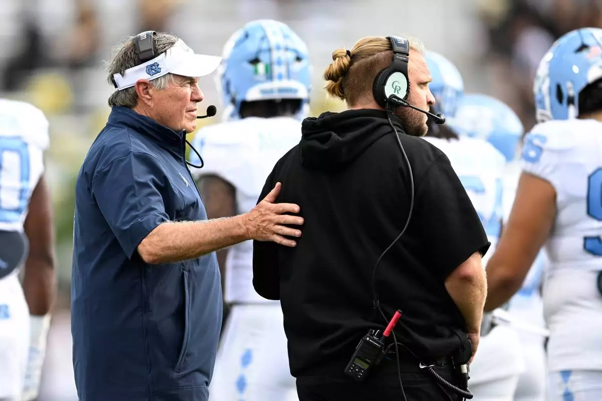 FILE - North Carolina head coach Bill Belichick, left, and defensive coordinator Steve Belichick look on during the first half of an NCAA football game against Central Florida, Saturday, Sept. 20, 2025, in Orlando, Fla. (AP Photo/Phelan M. Ebenhack, File)