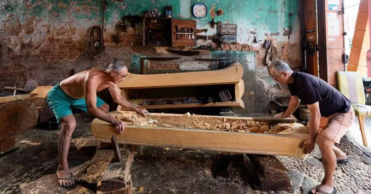 Two brothers carry on the traditional art of handmade Chinese coffins in Malaysia, in photos