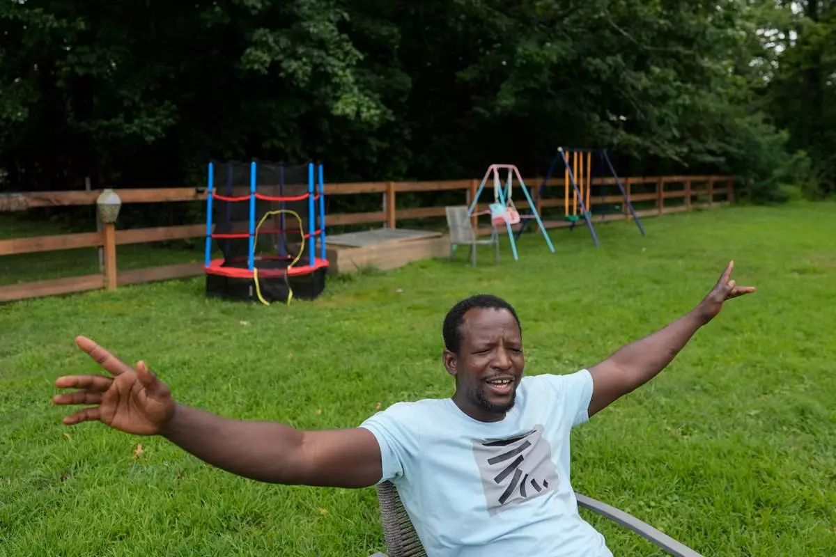 Khalidou Sy, a Mauritanian immigrant, talks in the backyard of his family's home in Lockland, Ohio, Friday, July 31, 2026. Sy feels like he’s part of a great American tradition, the “melting pot,” he said, like the Irish and Italians before him. (AP Photo/Carolyn Kaster)
