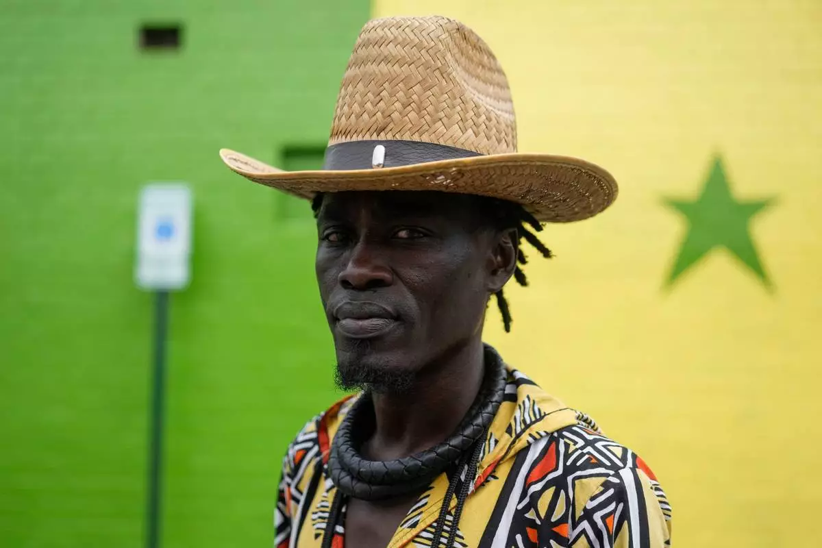 Mohamed, a Senegalese immigrant, pauses as he walks through the parking lot of Touba Tedoungal African Restaurant, Friday, July 31, 2026, in Lockland, Ohio, which has for decades been home to a small population of West Africans. (AP Photo/Carolyn Kaster)