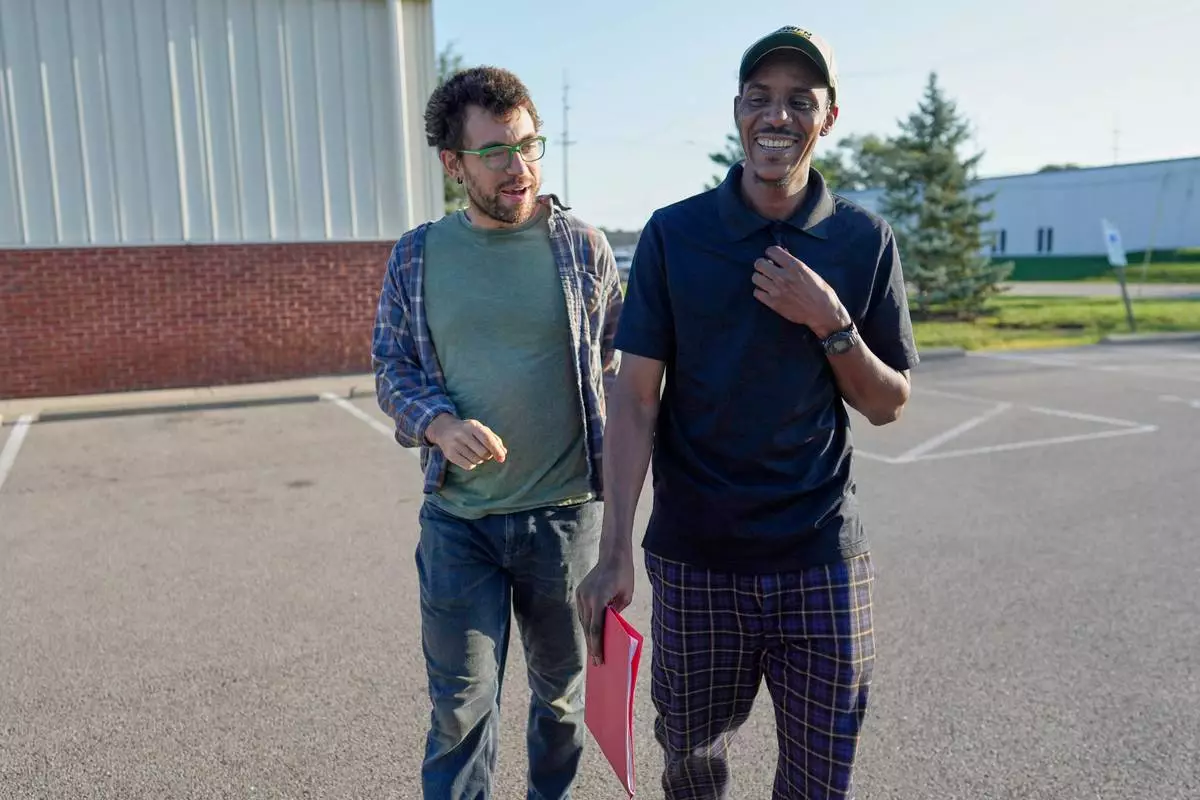 Vincent Wilson, left, walks with Samba Diallo, a Mauritanian immigrant back to Diallo's car after his regular appointment at an Immigration and Customs Enforcement office in Cincinnati, Monday, Sept. 14, 2026. (AP Photo/Carolyn Kaster)
