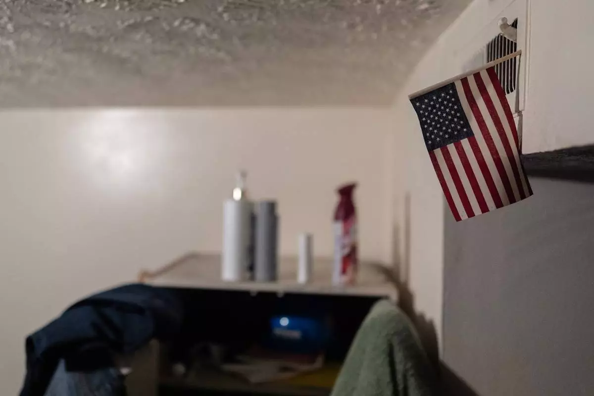 An American flag decorates Samba Diallo's bedroom in his shared apartment in Lockland, Ohio, Friday, July 17, 2026. Lockland had for decades been home to a small population of West Africans who'd come to Ohio in the 1990s. (AP Photo/Carolyn Kaster)