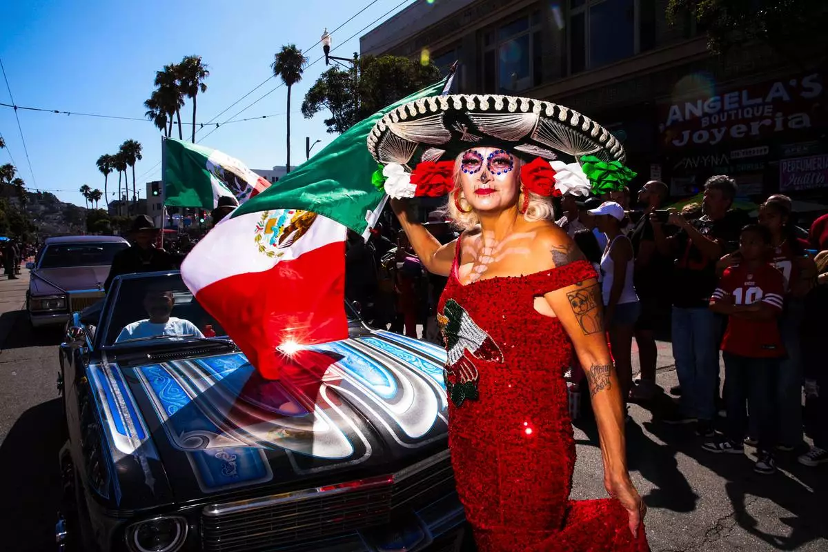 FILE - Lydia Rioss of Sacramento, poses for a portrait during King of the Streets, the world's first televised and streamed lowrider parade planned as part of National Latino-Hispanic Heritage Month, in San Francisco's Mission District on Sept. 20, 2025. (Yalonda M. James/San Francisco Chronicle via AP, File)