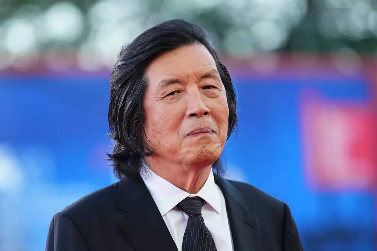 Lee Chang-Dong poses for photographers at the closing ceremony red carpet during the 83rd edition of the Venice Film Festival in Venice, Italy, on Saturday, Sept. 12, 2026. (Photo by Scott A Garfitt/Invision/AP)