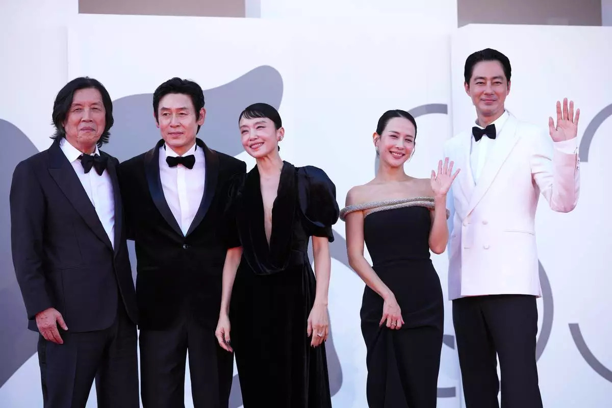Driector Lee Chang-dong, from left, Sul Kyung-gu, Jeon Do-yeon, Cho Yeo-jeong and Zo In-sung pose for photographers at the red carpet for the film 'Possible Love' during the 83rd edition of the Venice Film Festival in Venice, Italy, on Sunday, Sept. 6, 2026. (Photo by Alessandra Tarantino/Invision/AP)