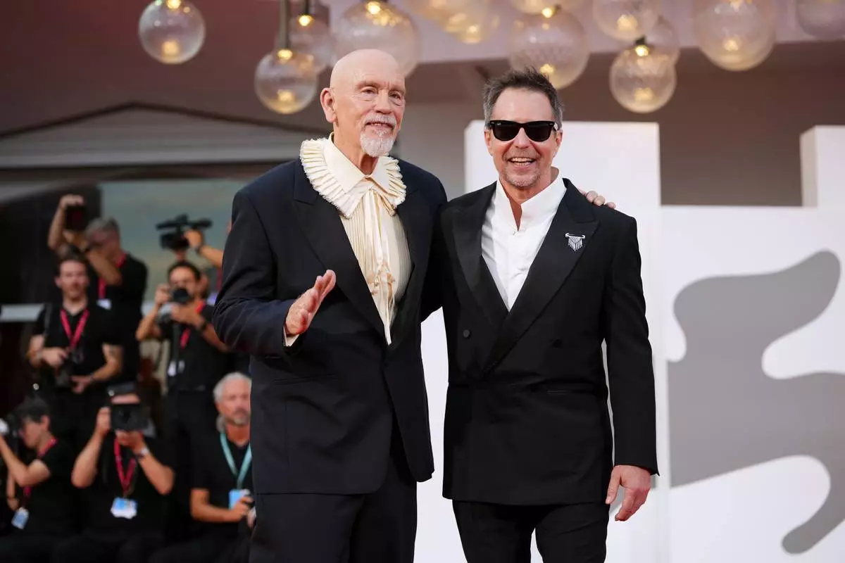 John Malkovich, left, and Sam Rockwell pose for photographers at the red carpet for the film 'Wild Horse Nine' during the 83rd edition of the Venice Film Festival in Venice, Italy, on Thursday, Sept. 3, 2026. (Photo by Alessandra Tarantino/Invision/AP)