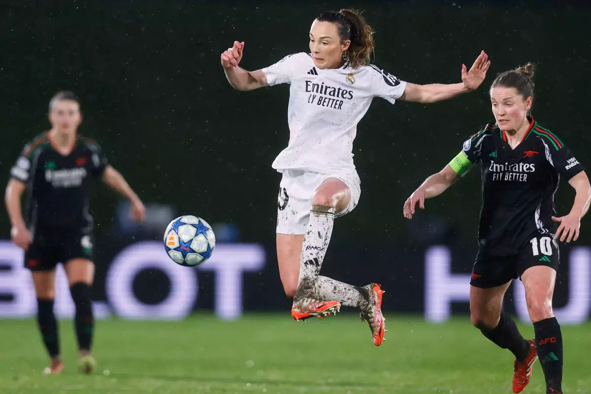 FILE - Real Madrid's Caroline Weir, center, jumps to control the ball in front of Arsenal's Kim Little, right, during the Women's Champions League quarterfinal first leg soccer match between Real Madrid and Arsenal at the Alfredo di Stefano stadium in Madrid, Spain, March 18, 2025. (AP Photo/Fran Berg, File)