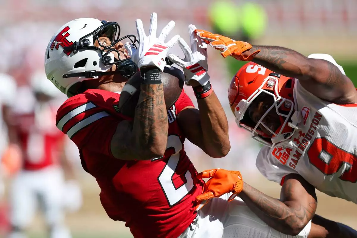Texas Tech wide receiver Kenny Johnson (2) makes a catch as Sam Houston State safety Jace Arnold defends during the first half of an NCAA college football game, Saturday, Sept. 26, 2026, in Lubbock, Texas. (AP Photo/Chase Seabolt)