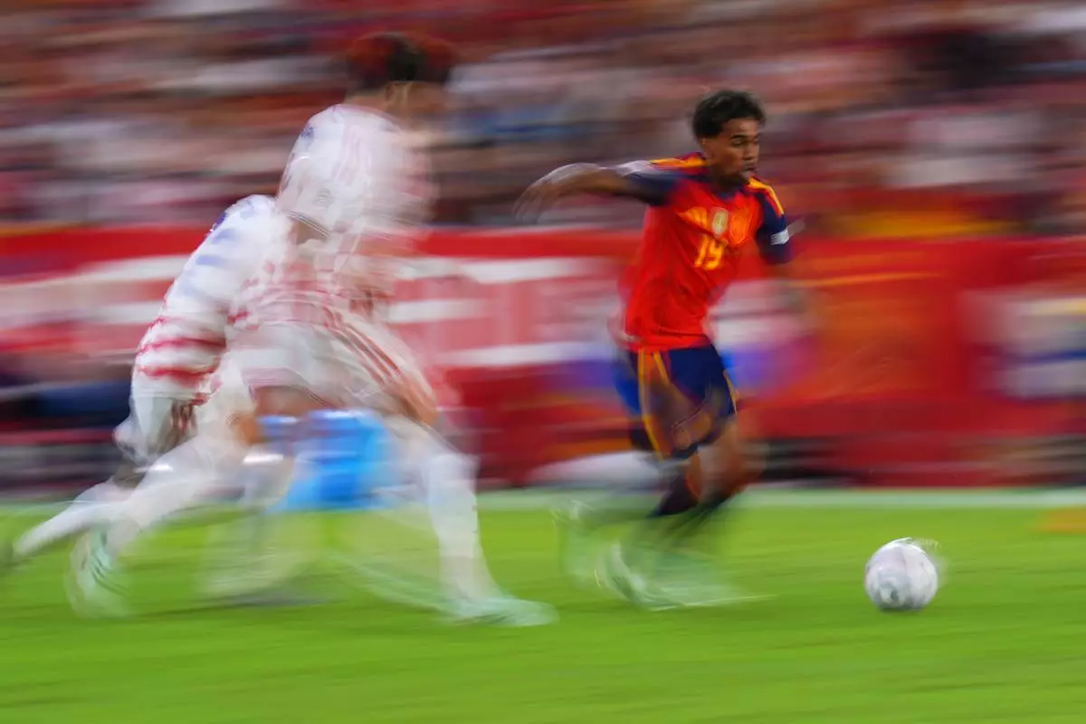 In this photo taken with slow shutter speed Spain's Lamine Yamal is in action during the Nations League soccer match between Spain and Croatia in Seville, Spain, Tuesday, Sept. 29, 2026. (AP Photo/Manu Fernandez)