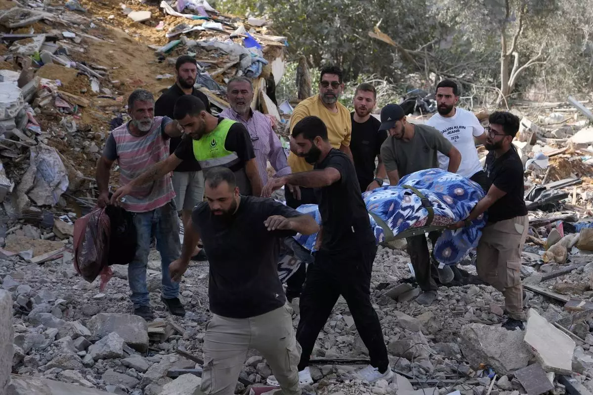 People carry a body of a person who was killed at a house that was hit by an Israeli airstrike in Arab Salim village, southern Lebanon, Sunday, Sept. 6, 2026. (AP Photo/Mohammed Zaatari) CORRECTION: Corrects village name to Arab Salim instead of Araba Salim
