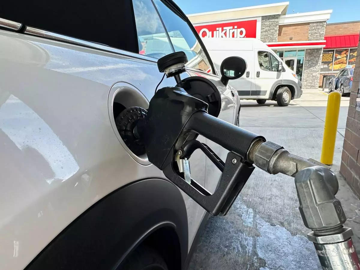 A motorist fills up the fuel tank of a vehicle at a QuikTrip gasoline stop Tuesday, Sept. 15, 2026, in Greenwood Village, Colo. (AP Photo/David Zalubowski)