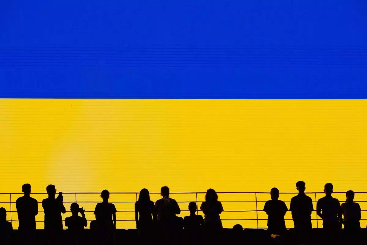 Spectators rise during Ukraine's national anthem at the Billie Jean King Cup women's singles final between Ukraine and the Czech Republic, in Shenzhen, China, Sunday, Sept. 27, 2026. (AP Photo/Andy Wong)