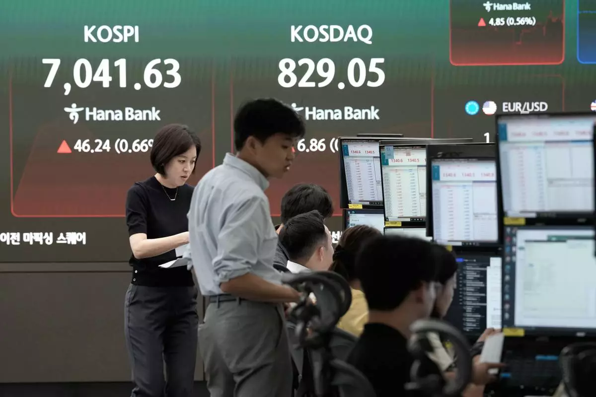 Currency traders work near a screen showing the Korea Composite Stock Price Index (KOSPI) at the foreign exchange dealing room of the Hana Bank headquarters in Seoul, South Korea, Tuesday, Sept. 8, 2026. (AP Photo/Ahn Young-joon)