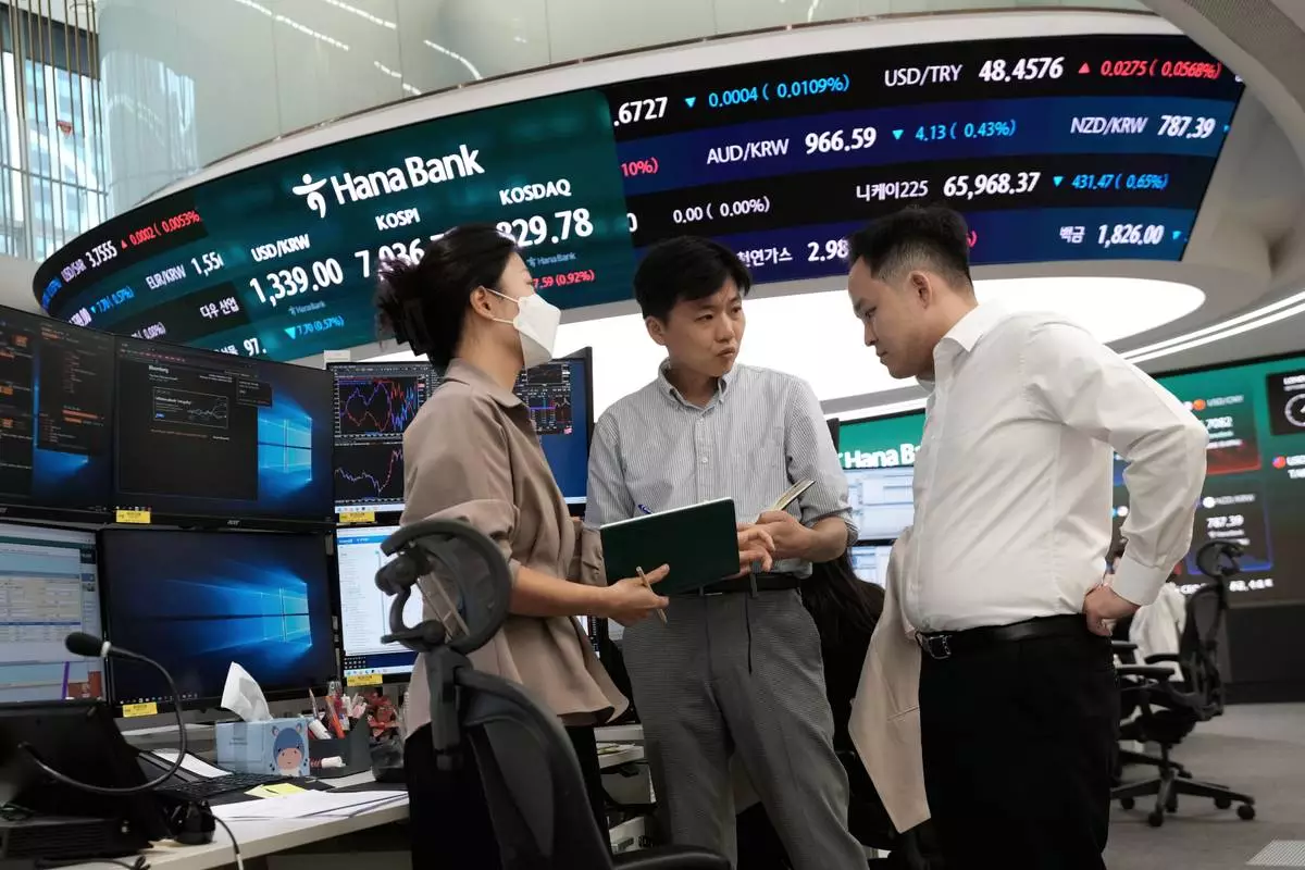 Currency traders work at the foreign exchange dealing room of the Hana Bank headquarters in Seoul, South Korea, Tuesday, Sept. 8, 2026. (AP Photo/Ahn Young-joon)