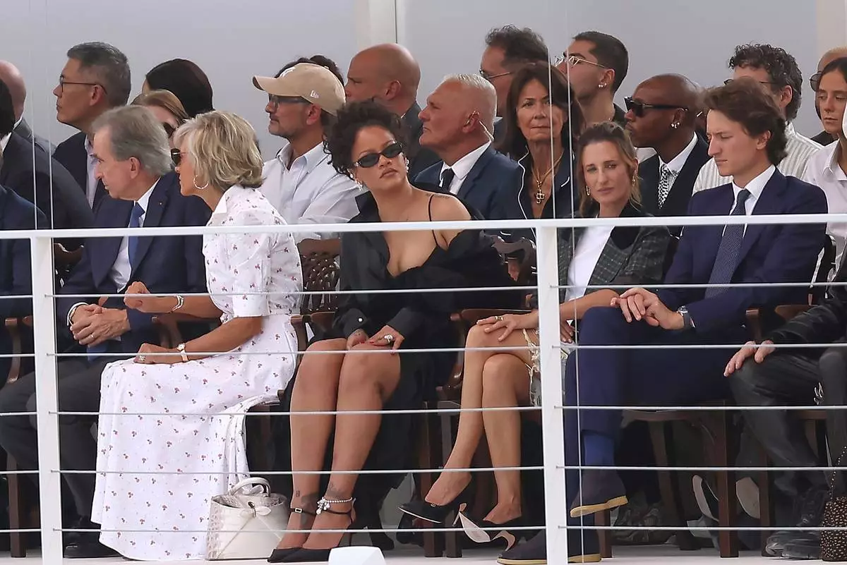 Rihanna, centre, and Camille Cottin, centre right, watch the Christian Dior Womenswear Spring Summer 2027 collection presented in Paris, France, Tuesday, Sept. 29, 2026. (AP Photo/Thomas Padilla)