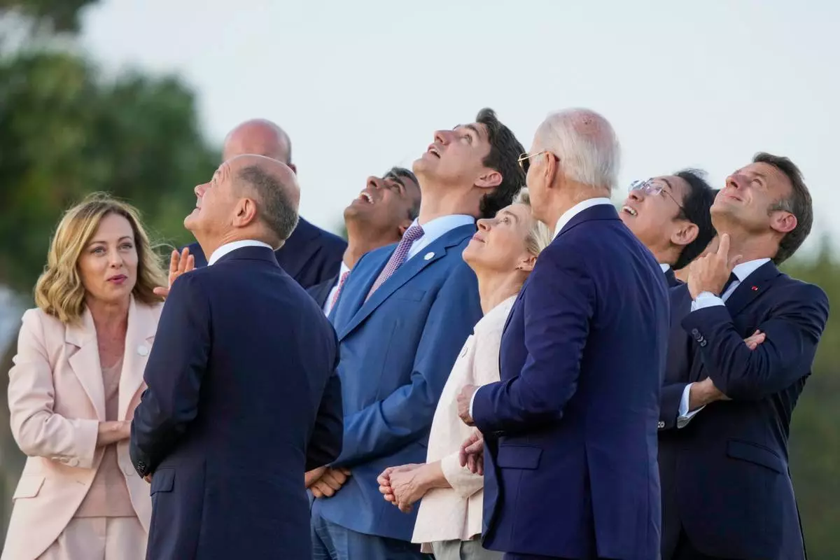 FILE -- From right, French President Emmanuel Macron, Japan's Prime Minister Fumio Kishida, U.S. President Joe Biden, European Commission President Ursula von der Leyen, Canada's Prime Minister Justin Trudeau, Britain's Prime Minister Rishi Sunak, European Council President Charles Michel, German Chancellor Olaf Scholz and Italian Prime Minister Giorgia Meloni watch a skydiving demo during the G7 world leaders summit at Borgo Egnazia, Italy, Thursday, June 13, 2024. (AP Photo/Luca Bruno, File)