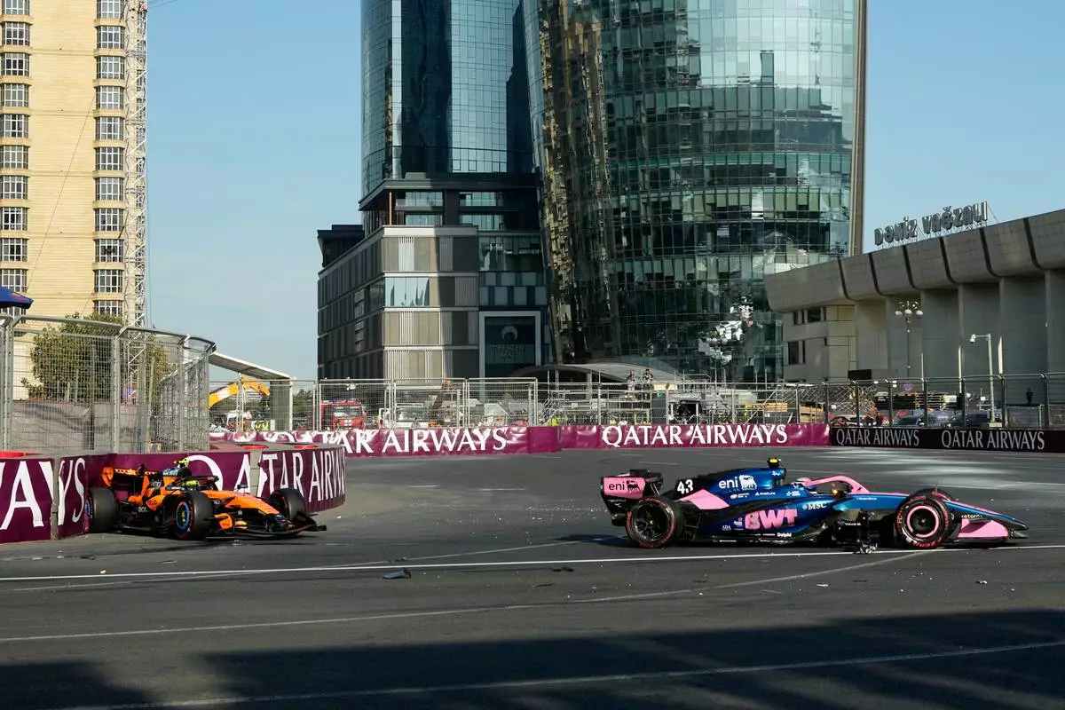 McLaren driver Lando Norris of Britain and Alpine driver Franco Colapinto of Argentina sit in their cars after crashing during the Azerbaijan F1 Grand Prix race, in Baku, Azerbaijan, Saturday, Sept. 26, 2026. (AP Photo/Darko Bandic)