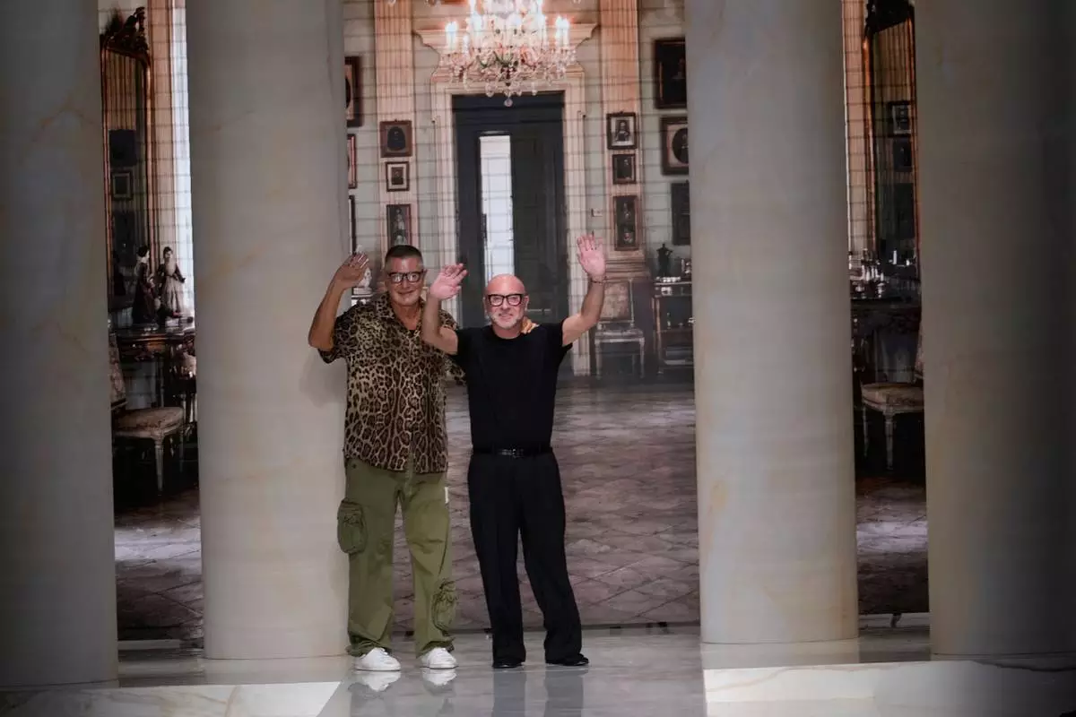 Stefano Gabbana and Domenico Dolce accept applause at the end of the Dolce & Gabbana women's Spring-Summer 2027 fashion show, presented in Milan, Italy, Saturday, Sept. 26, 2026. (AP Photo/Luca Bruno)