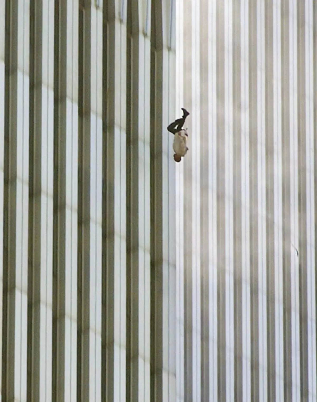 EDITORS: NOTE GRAPHIC CONTENT--- FILE - A person falls head first from the north tower of New York's World Trade Center, Sept. 11, 2001. (AP Photo/Richard Drew, File)
