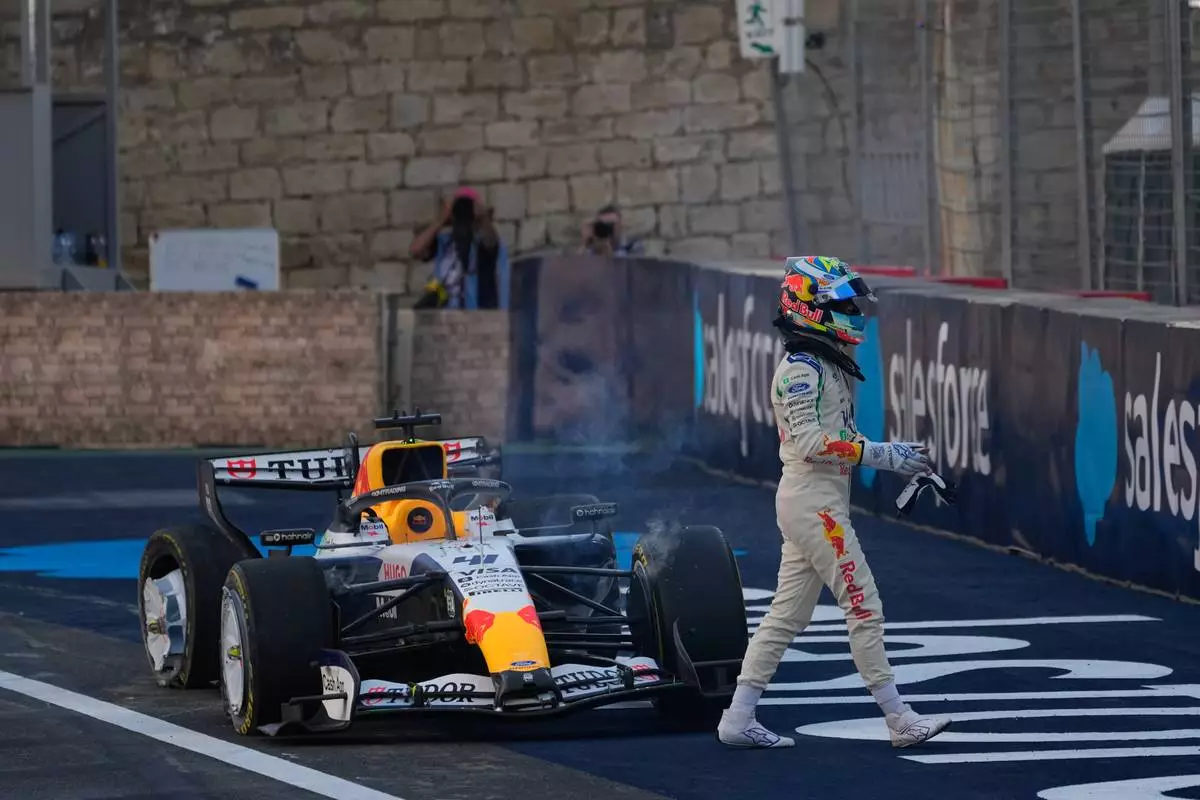 Racing Bulls driver Arvid Lindblad of Britain walks away after hitting a wall during the second free practice ahead of the Azerbaijan F1 Grand Prix, in Baku, Azerbaijan, Thursday, Sept. 24, 2026. (AP Photo/Darko Bandic)