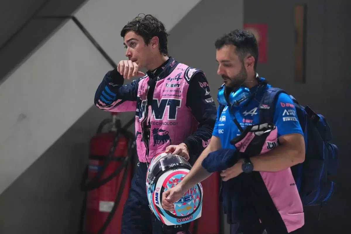 Alpine driver Franco Colapinto, left, of Argentina walks away during the sprint qualifying session ahead of the Singapore Formula One Grand Prix in Singapore, Friday, Oct. 9, 2026. (AP Photo/Ng Han Guan, Pool)