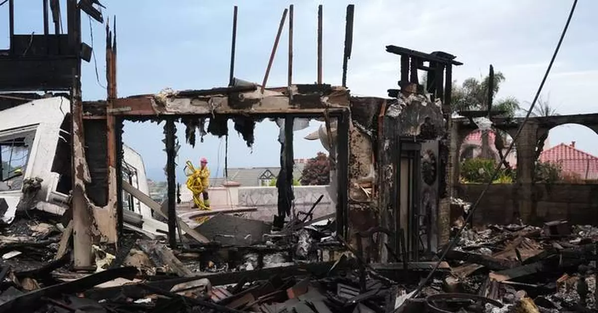 Photos show wildfire fueled by high winds engulfing coastal homes in Southern California