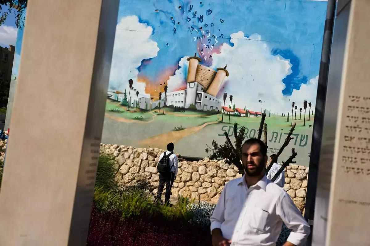 People visit a memorial at a police station attacked by Hamas on Oct. 7 three years prior, in Sderot, southern Israel, Sunday, Oct. 4, 2026. (AP Photo/Oded Balilty)