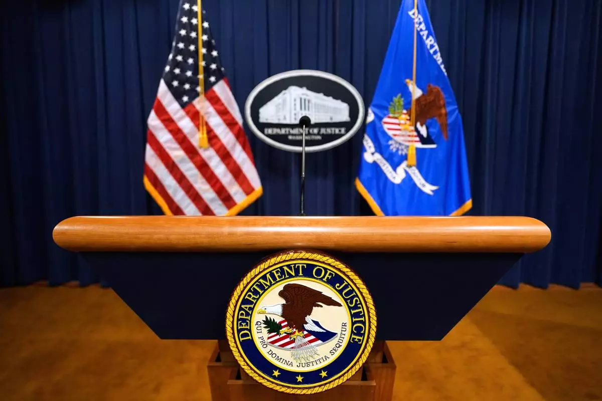 FILE - The U.S. Department of Justice logo is seen on a podium before a press conference, May 6, 2025, at the Justice Department in Washington. (AP Photo/Julia Demaree Nikhinson, File)