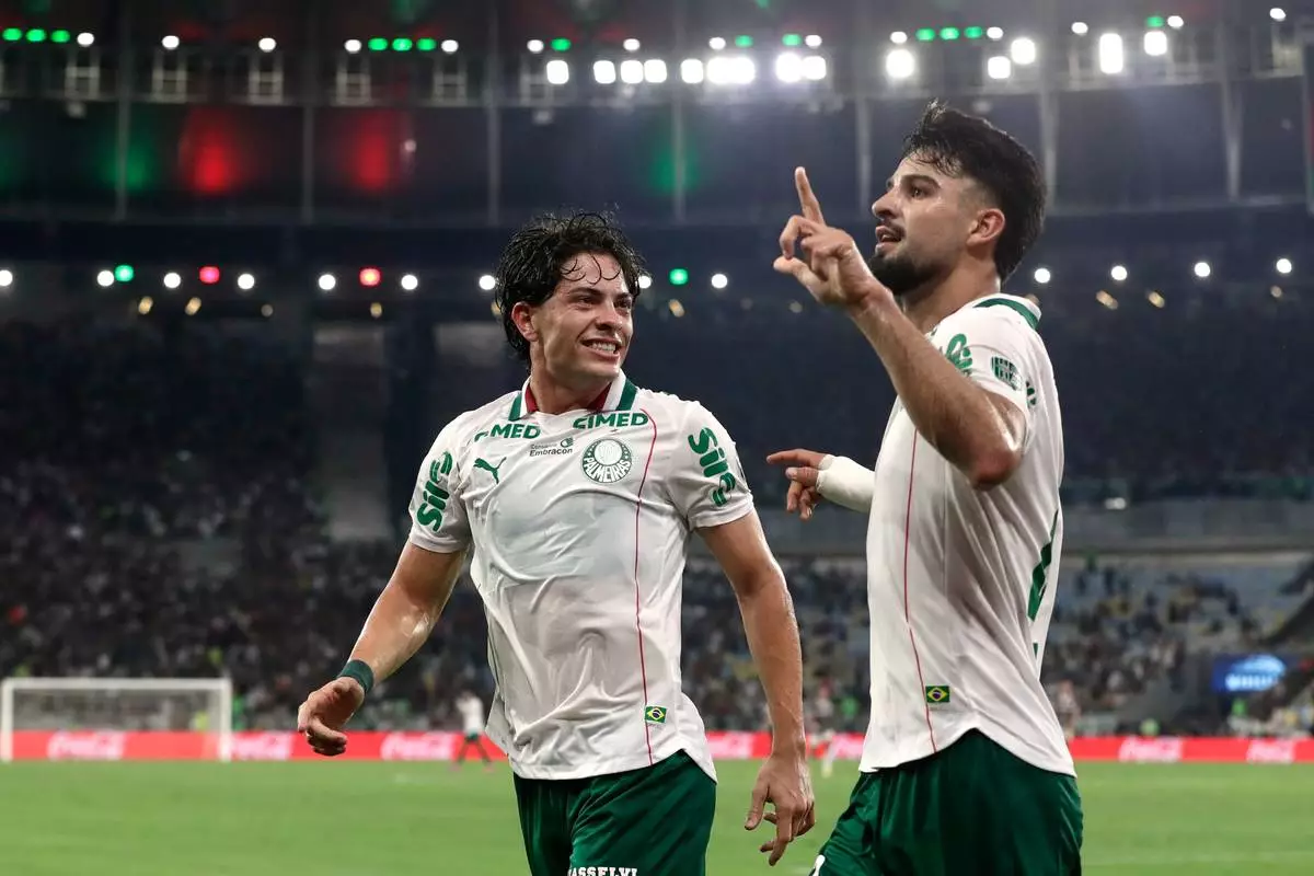 Flaco Lopez of Brazil's Palmeiras, right, celebrates with teammate Agustin Giay after scoring his side's opening goal against Brazil's Fluminense during the first leg of a Copa Libertadores semifinal soccer match in Rio de Janeiro, Wednesday, Oct. 14, 2026. (AP Photo/Bruna Prado)
