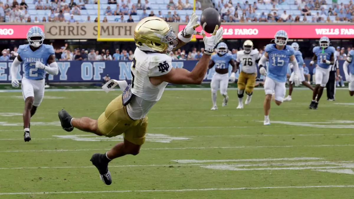 Notre Dame wide receiver Jordan Faison (6) pulls in a touchdown pass against North Carolina during the first half of an NCAA college football game Saturday, Oct. 3, 2026, in Chapel Hill, N.C. (AP Photo/Chris Seward)