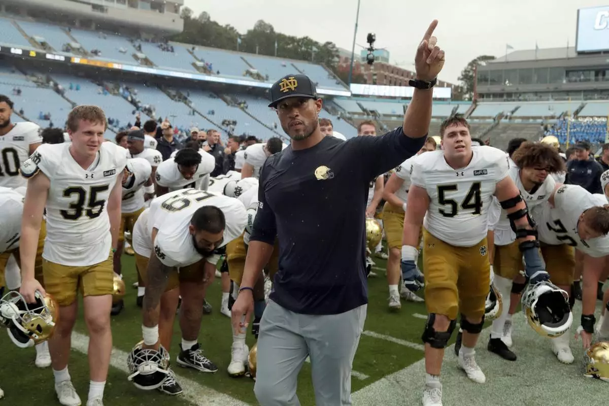 Notre Dame head coach Marcus Freeman and the team recognize their fans at the end of an NCAA college football game against North Carolina, Saturday, Oct. 3, 2026, in Chapel Hill, N.C. (AP Photo/Chris Seward)