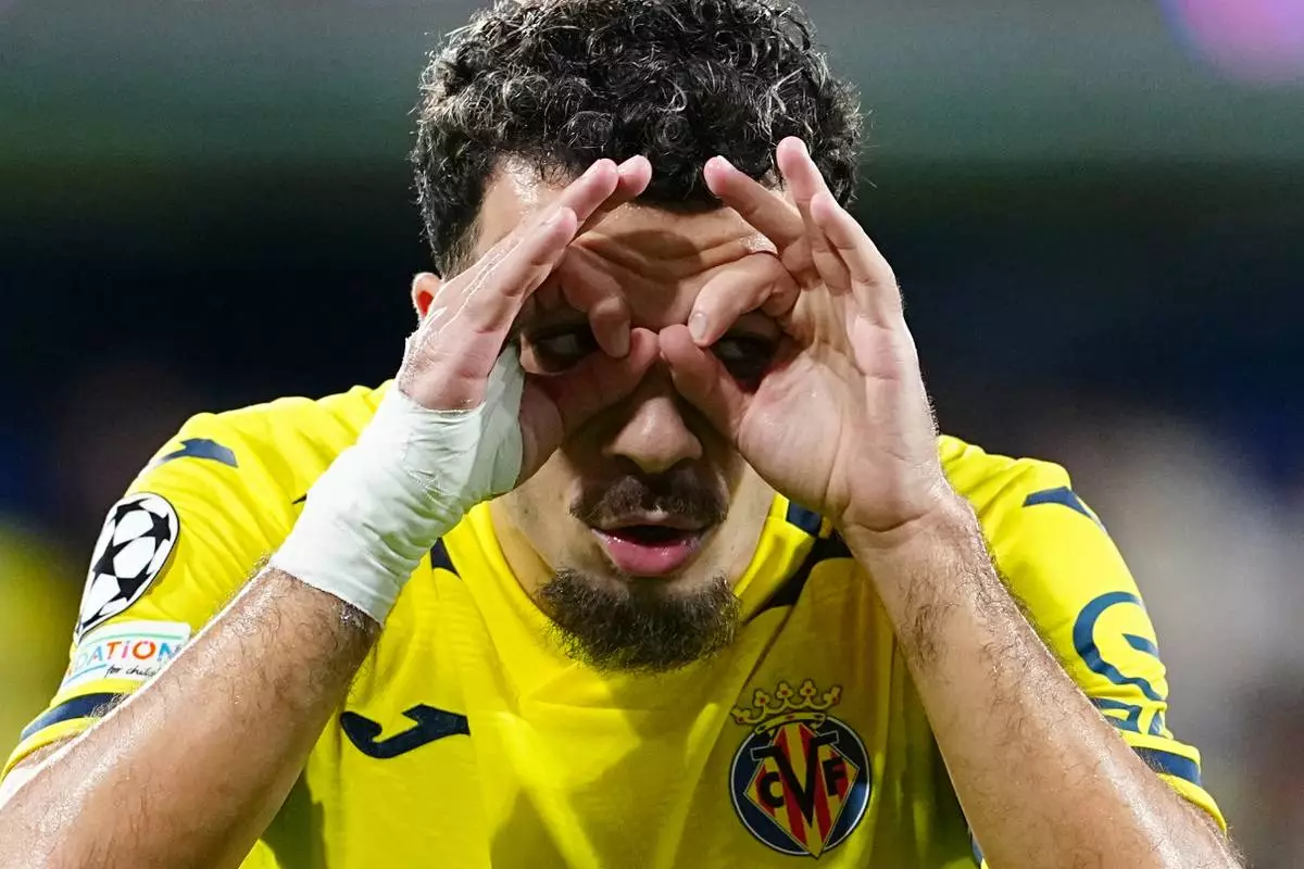 Villarreal's Georges Mikautadze celebrates after scoring his side's opening goal during their Champions League opening phase soccer match between Villarreal and Napoli, in Villarreal, Spain, Tuesday, Oct. 13, 2026. (AP Photo/Alberto Saiz)