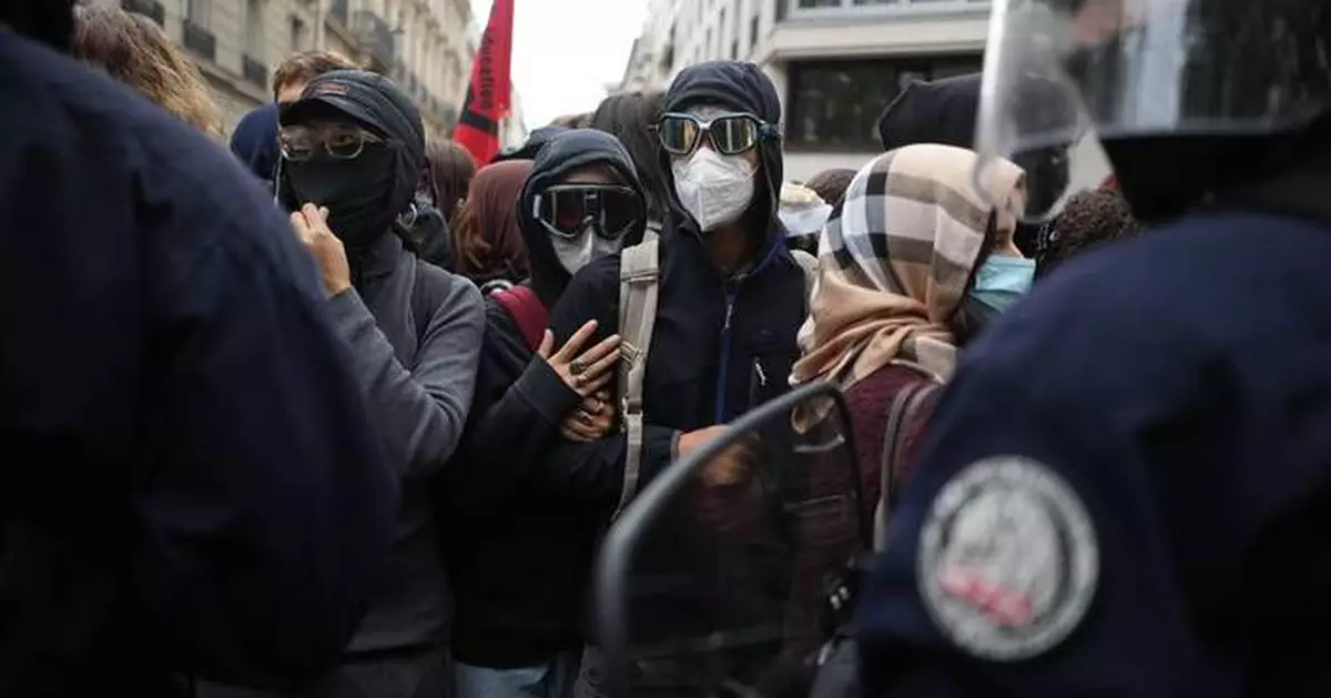 Police fire tear gas at a barricaded high school in Paris as school protests show no sign of ending