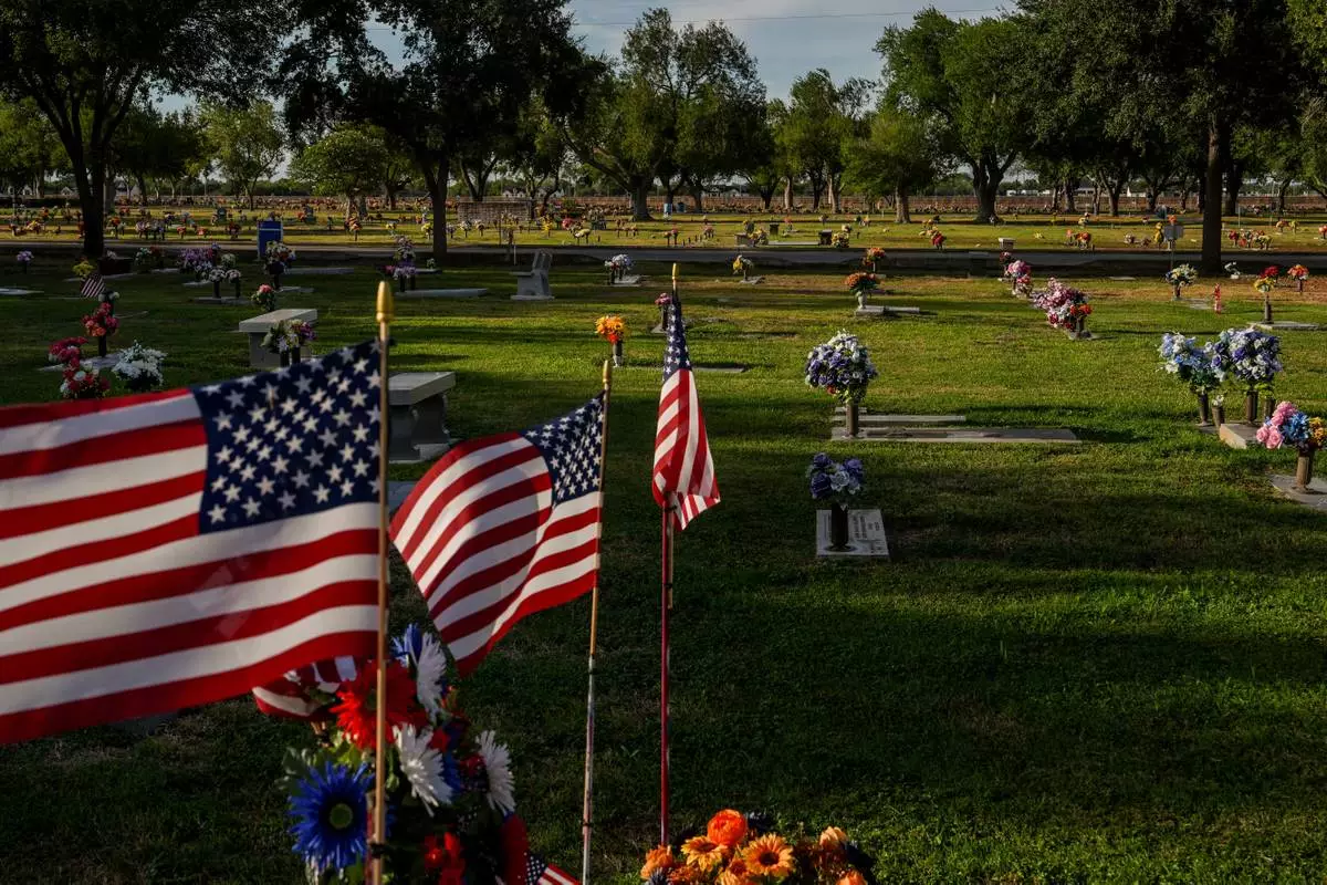 American flags fly over graves at Funeraria del Angel Highland Funeral Home and Memorial Park, where Melissa Banda is entombed, Sept. 17, 2026, in Weslaco, Texas. (AP Photo/Julia Demaree Nikhinson)