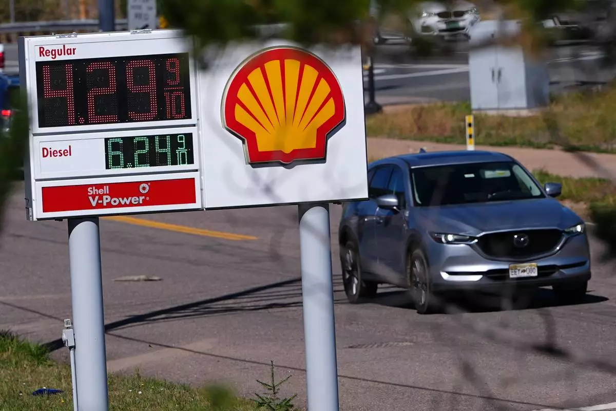 A motorist drives past a sign posting the per-gallon prices for regular unleaded and diesel fuel at a Shell gasoline station Monday, Oct. 5, 2026, in Evergreen, Colo. (AP Photo/David Zalubowski)