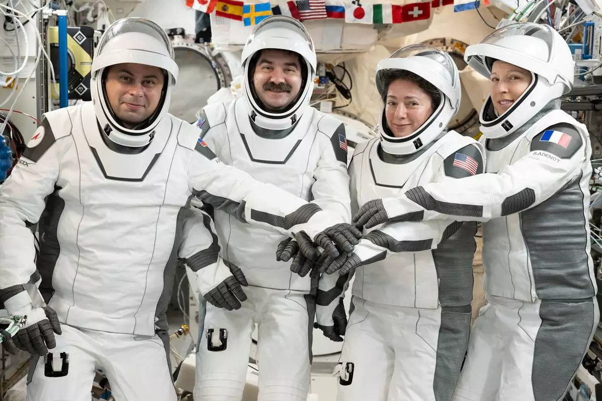 This image provided by NASA on Tuesday Oct. 6, 2026, SpaceX Crew-12 members, from left, Roscosmos cosmonaut and mission specialist Andrey Fedyaev, NASA astronauts Jack Hathaway and Jessica Meir, Crew-12 pilot and commander respectively, and ESA (European Space Agency) astronaut and mission specialist Sophie Adenot, gather for a portrait in the pressure suits they will wear when they depart the International Space Station inside the SpaceX Dragon spacecraft. (Anil Menon/NASA via AP)