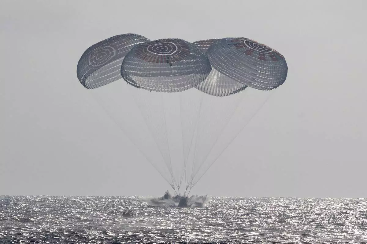 In this photo provided by NASA, the SpaceX Crew Dragon Freedom spacecraft splashes down in the Pacific Ocean off the coast of California on Thursday, Oct. 8, 2026, returning from the International Space Station. (Keegan Barber/NASA via AP)
