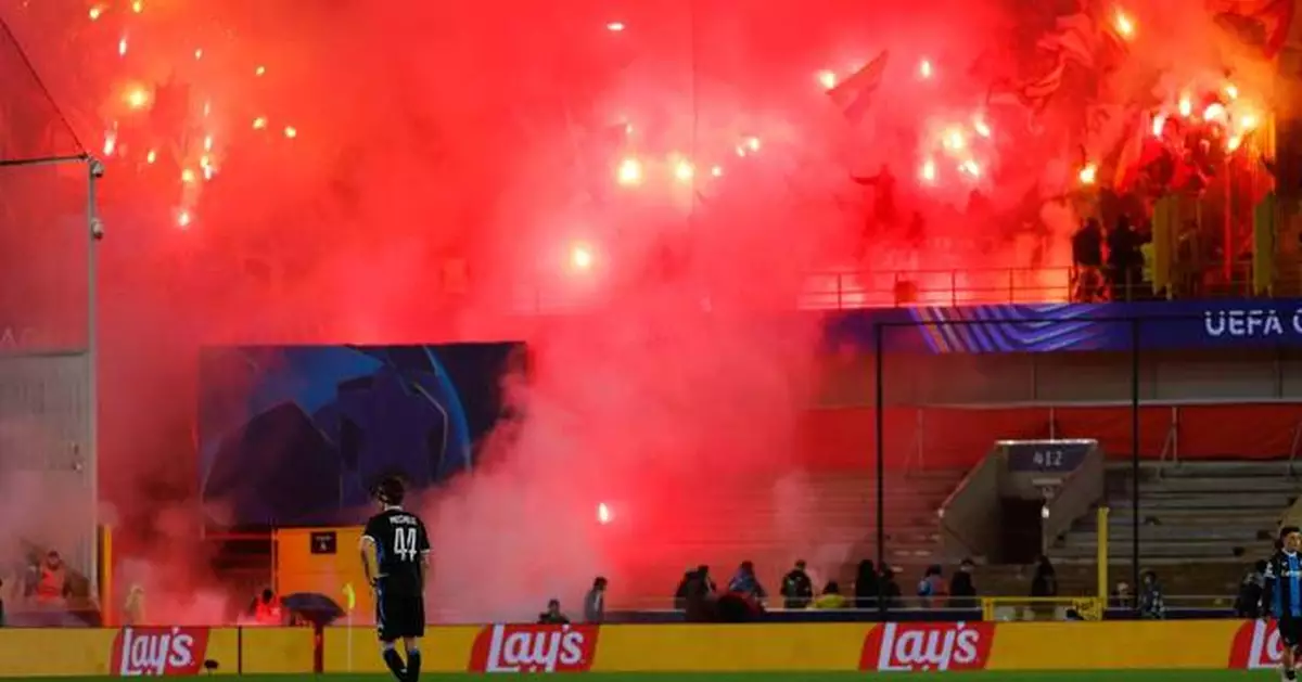 Lens fans banned from Liverpool game in Champions League for throwing flares that stopped play