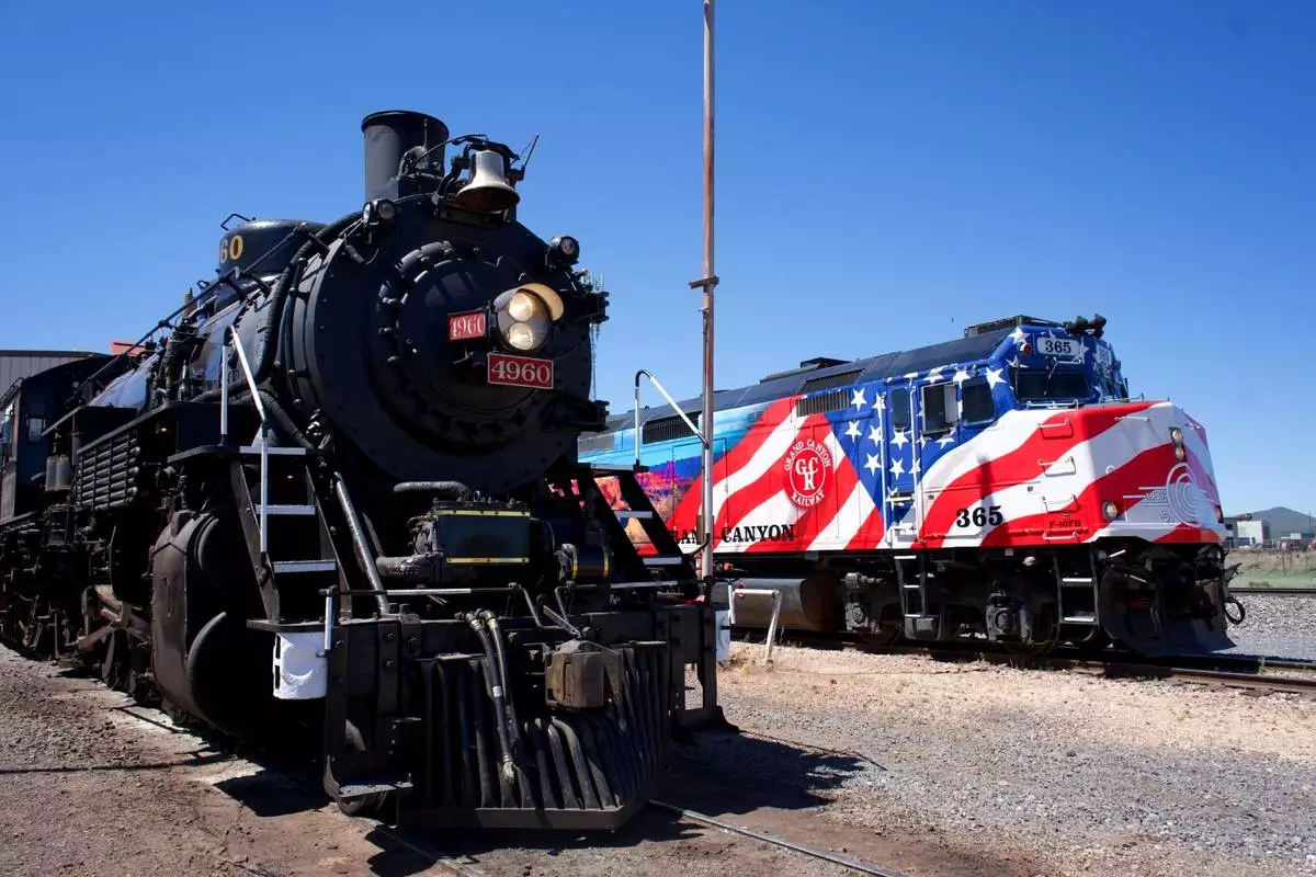 The Grand Canyon Railway & Hotel celebrated America's 250th with the A250, pictured here (right) next to a historic steam train (left). 2026 is also the 125th anniversary of the railway and the 150th anniversary of the Fred Harvey Company. Photo courtesy of Xanterra Travel Collection.