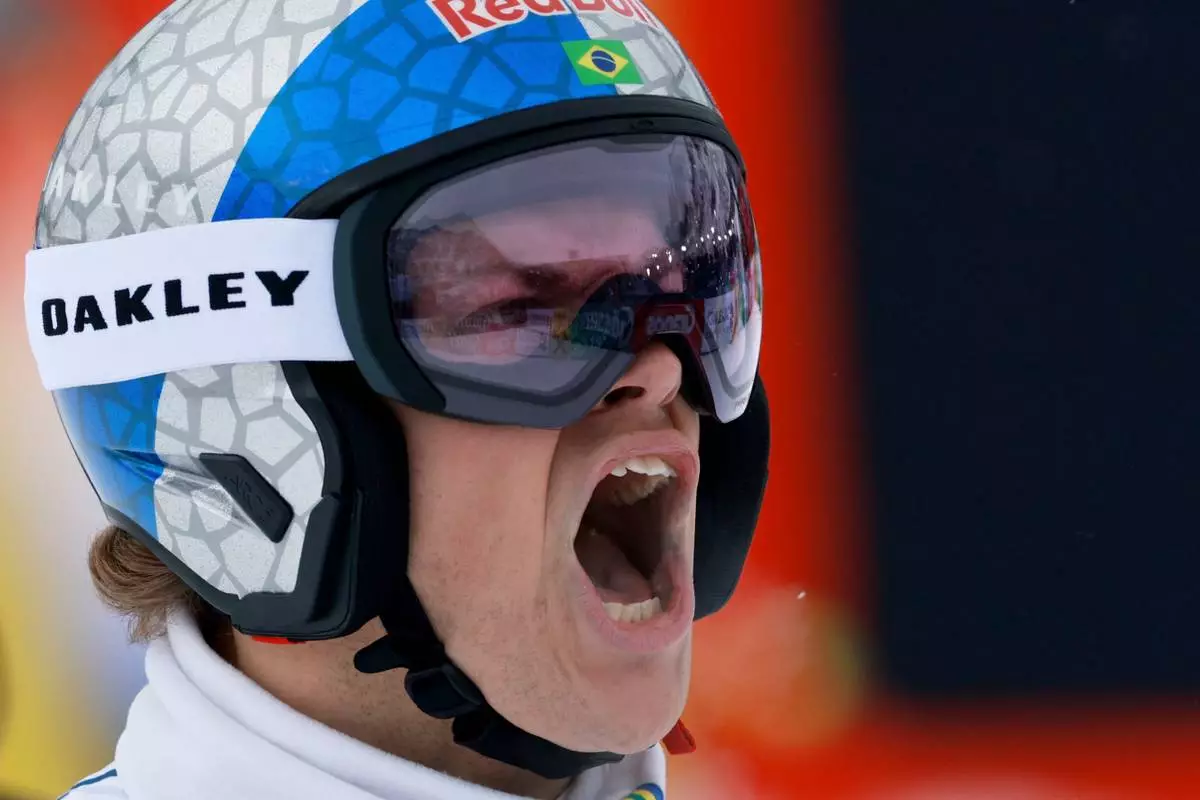 Brazil's Lucas Pinheiro Braathen celebrates at the finish area of an alpine ski, men's World Cup giant slalom, in Soelden, Austria, Sunday, Oct. 25, 2026. (AP Photo/Alessandro Trovati)