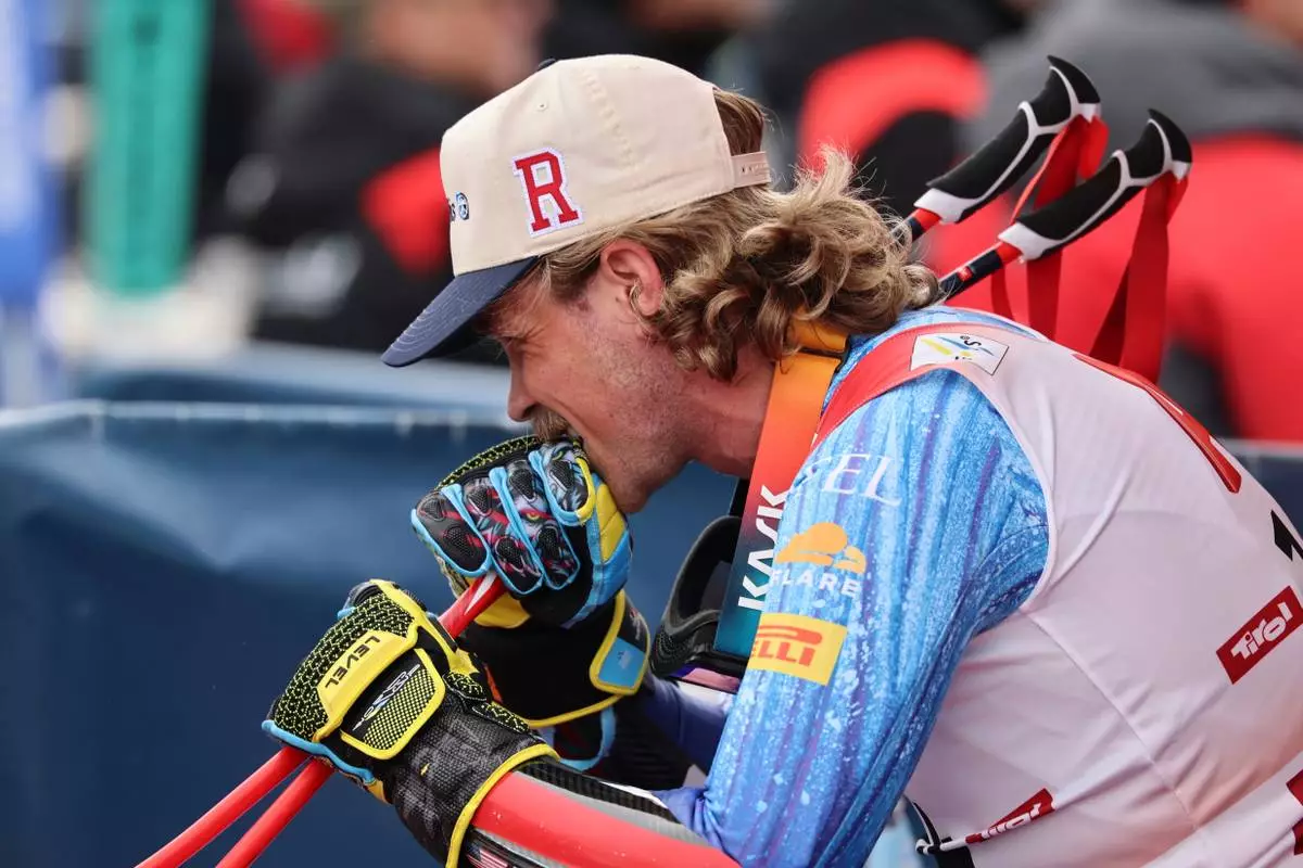 United States' River Radamus bites his glove as he sits in the leaders corner watching an alpine ski, men's World Cup giant slalom, in Soelden, Austria, Sunday, Oct. 25, 2026. (AP Photo/Marco Trovati)