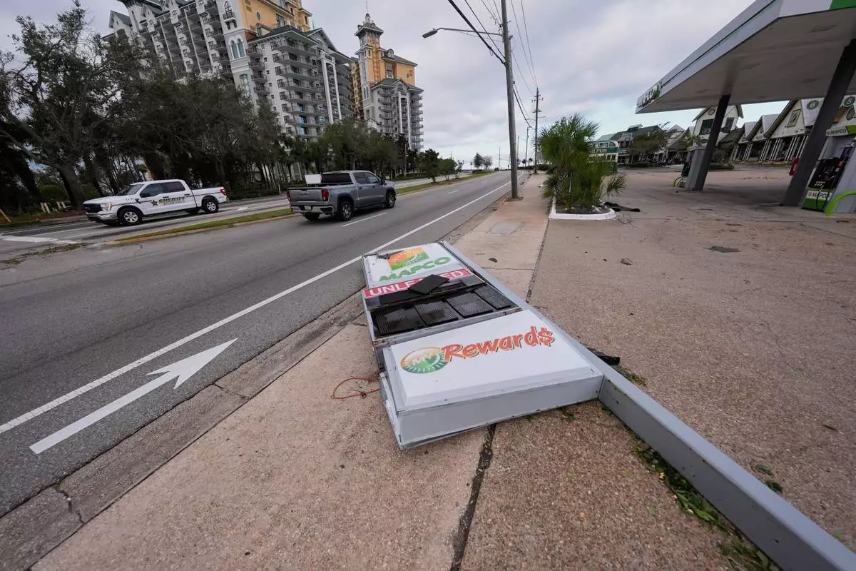 A gas station sign that was knocked down lies near the roadway in the aftermath of Hurricane Isaias in Destin, Fla., Saturday, Oct. 10, 2026. (AP Photo/Gerald Herbert)