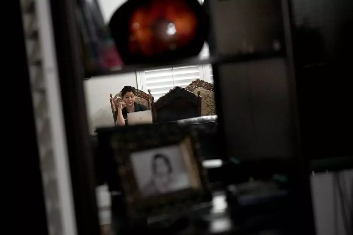 Cindy Banda participates in a work meeting from home, Sept. 15, 2026, in McAllen, Texas. (AP Photo/Julia Demaree Nikhinson)