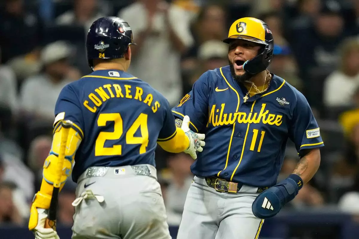 Milwaukee Brewers' Jackson Chourio (11) celebrates after scores on a hit by Christian Yelich during the third inning of Game 3 of baseball's World Series, Monday, Oct. 26, 2026, in St. Petersburg, Fla., between the Milwaukee Brewers and the Tampa Bay Rays. (AP Photo/Ashley Landis)