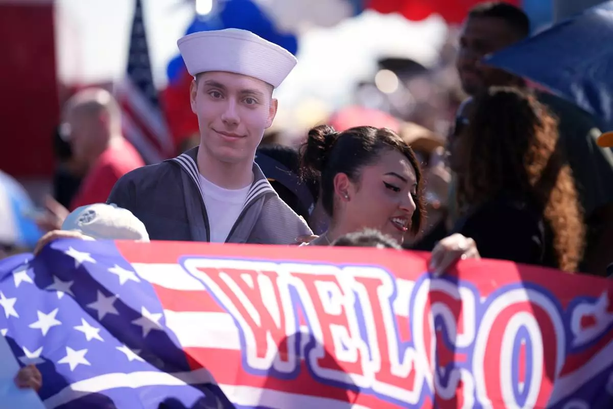 Family and friends gather to welcome sailor Frankie Valdovinos as the USS Abraham Lincoln aircraft carrier returns to Naval Air Station North Island after deployment Thursday, Oct. 8, 2026, in Coronado, Calif. (AP Photo/Gregory Bull)
