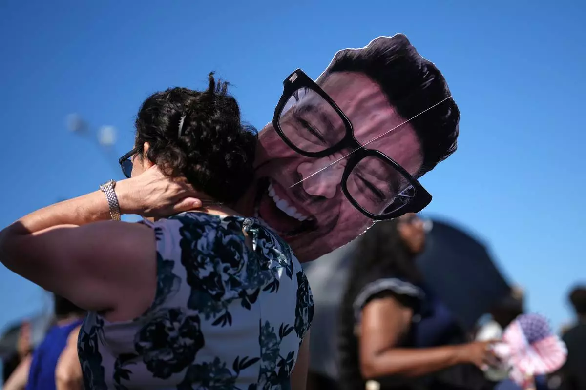 Ofelia Woodruff waits to greet her son, sailor Michael Woodruff, as the USS Abraham Lincoln aircraft carrier returns to Naval Air Station North Island after deployment Thursday, Oct. 8, 2026, in Coronado, Calif. (AP Photo/Gregory Bull)