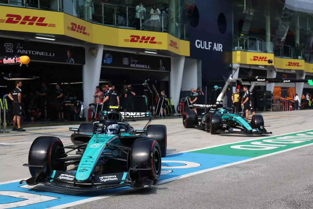 Mercedes driver Andrea Kimi Antonelli of Italy, left, and his teammate George Russell of Britain steer their cars out from the garage during the qualifying session for the Bahrain Grand Prix in Sepang, Malaysia, Saturday, Oct. 3, 2026. (Annice Lyn/Pool via AP )