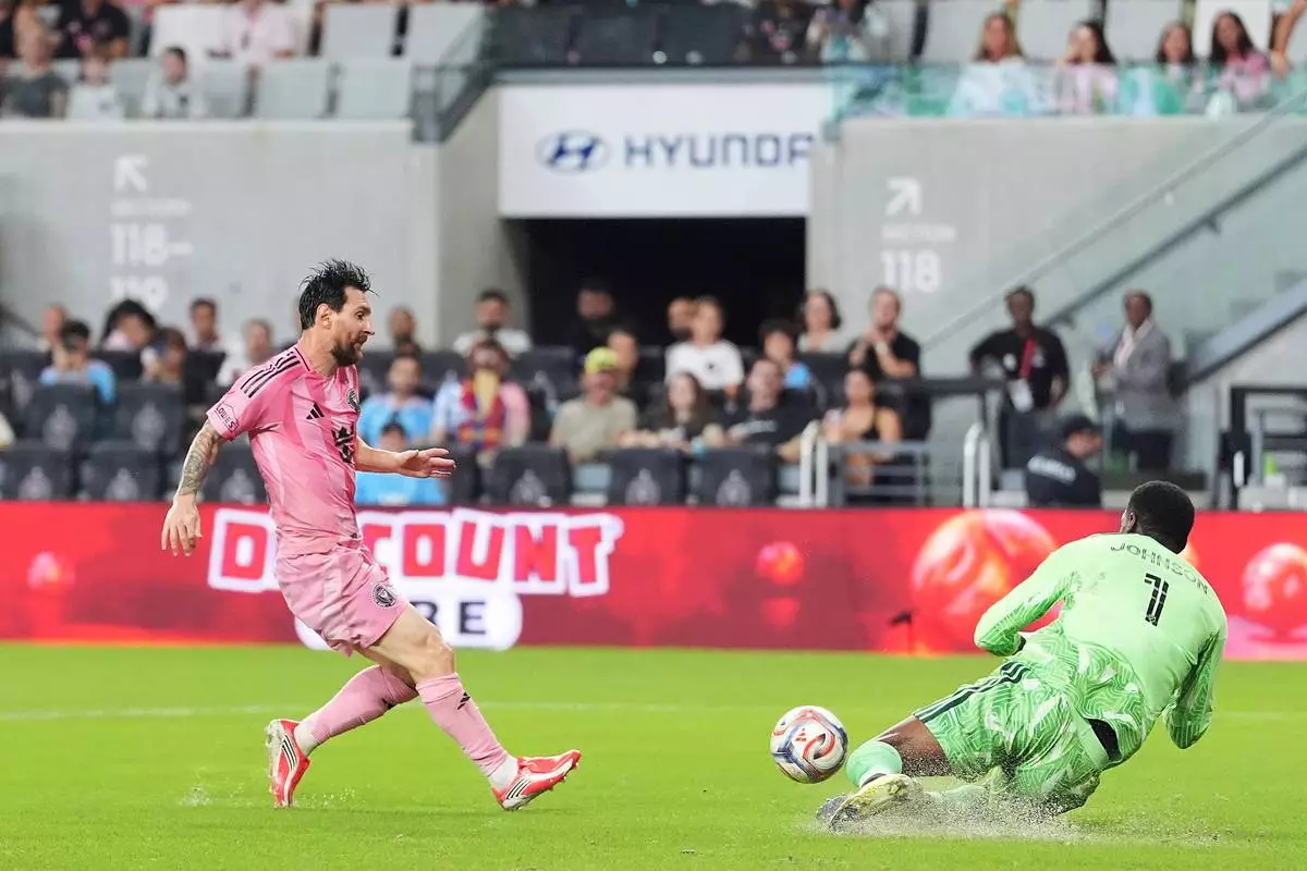 D.C. United goalkeeper Sean Johnson (1) stops a scoring attempt from Inter Miami forward Lionel Messi during the first half of an MLS soccer match, Saturday, Oct. 10, 2026, in Miami. (AP Photo/Rebecca Blackwell)